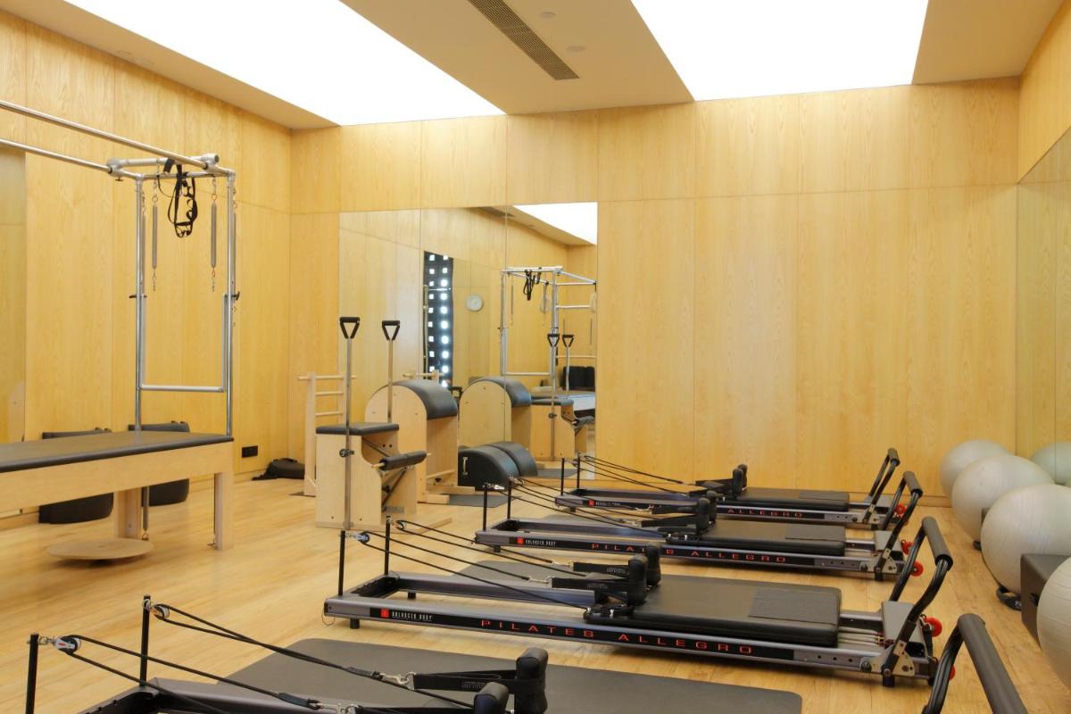 a gym with a row of treadmills and machines at The Lodhi – A member of The Leading Hotels Of The World in New Delhi