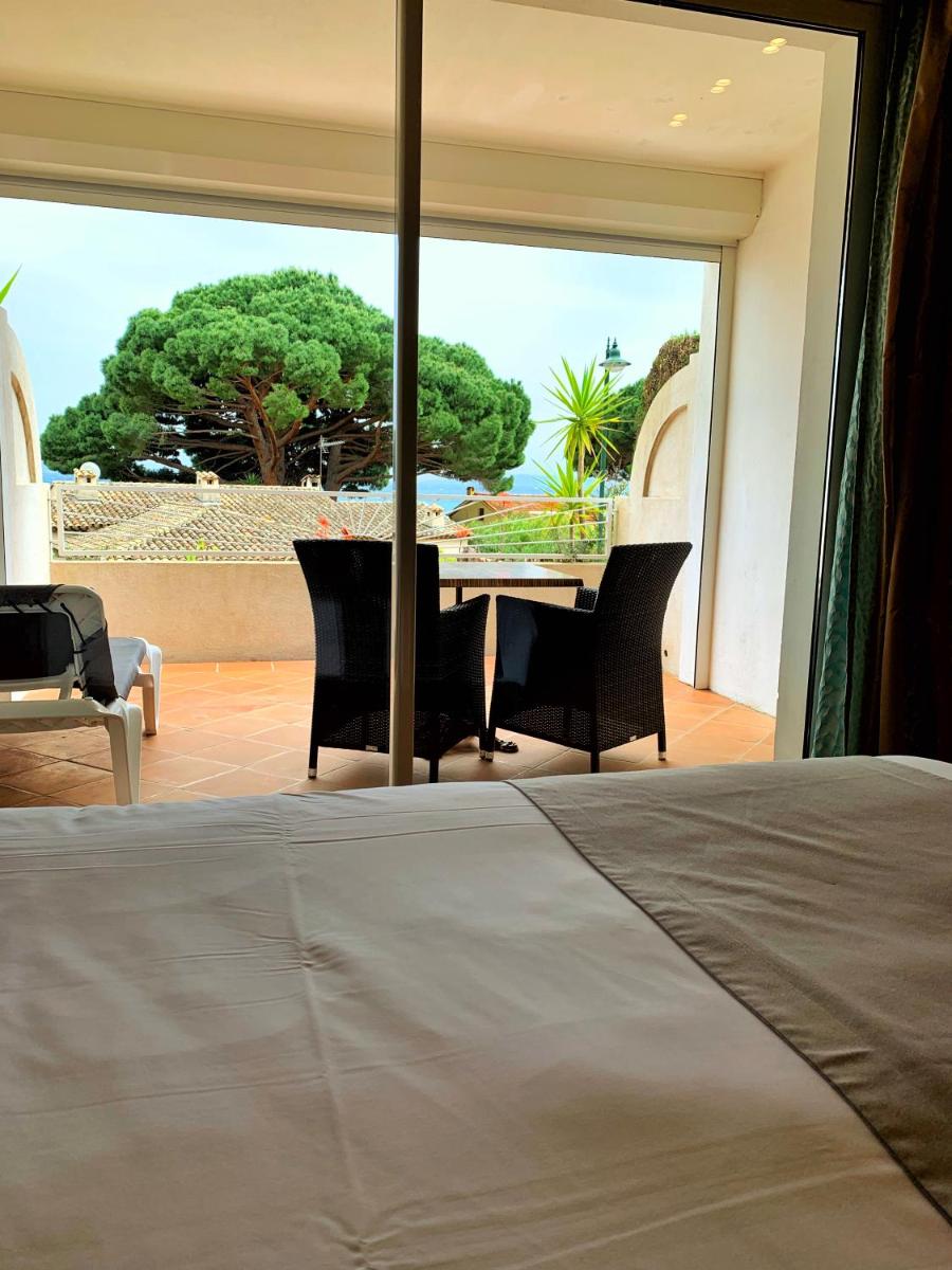 Un ou plusieurs lits dans un hébergement de l'établissement Hôtel Beau Soleil