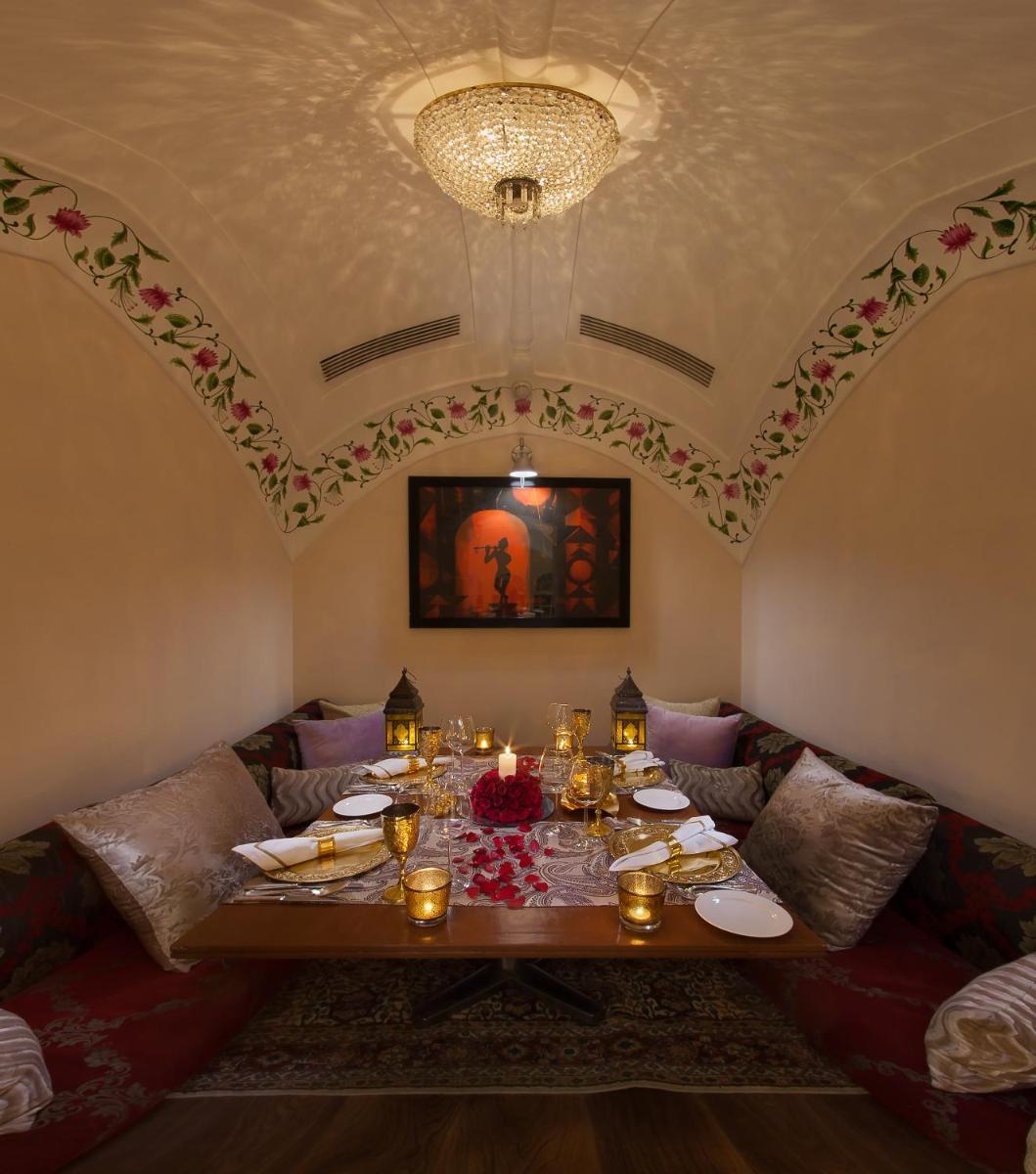 a dining room with a table with food on it at Jai Mahal Palace in Jaipur