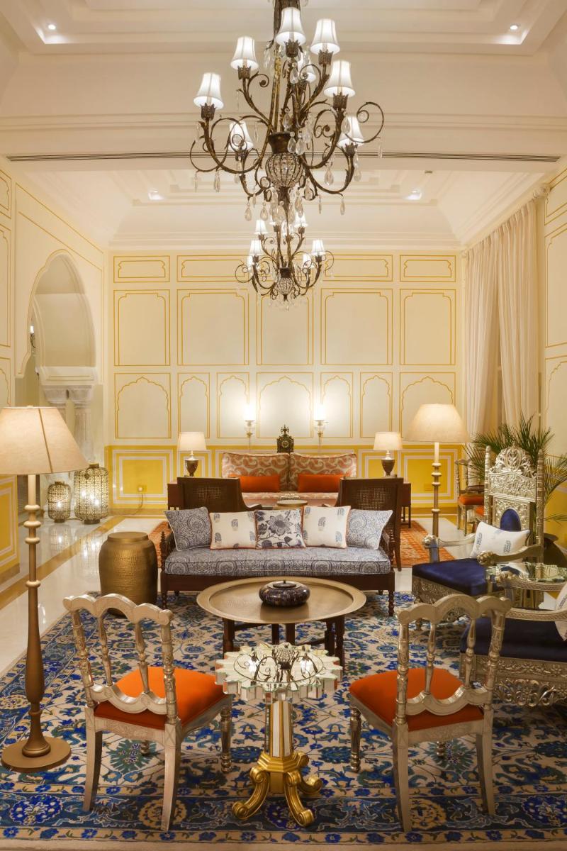 a living room with a couch and chairs and a chandelier at Jai Mahal Palace in Jaipur