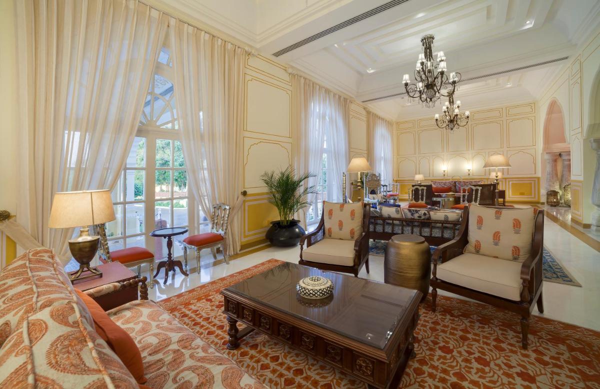 a living room with a couch and a table at Jai Mahal Palace in Jaipur