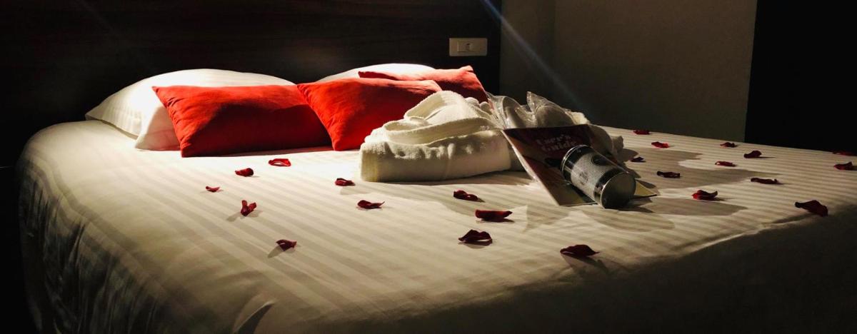 Un ou plusieurs lits dans un hébergement de l'établissement Hôtel Le Belvedere