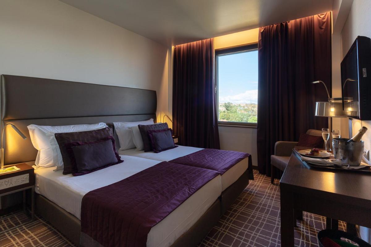 Uma cama ou camas num quarto em NEYA Lisboa Hotel