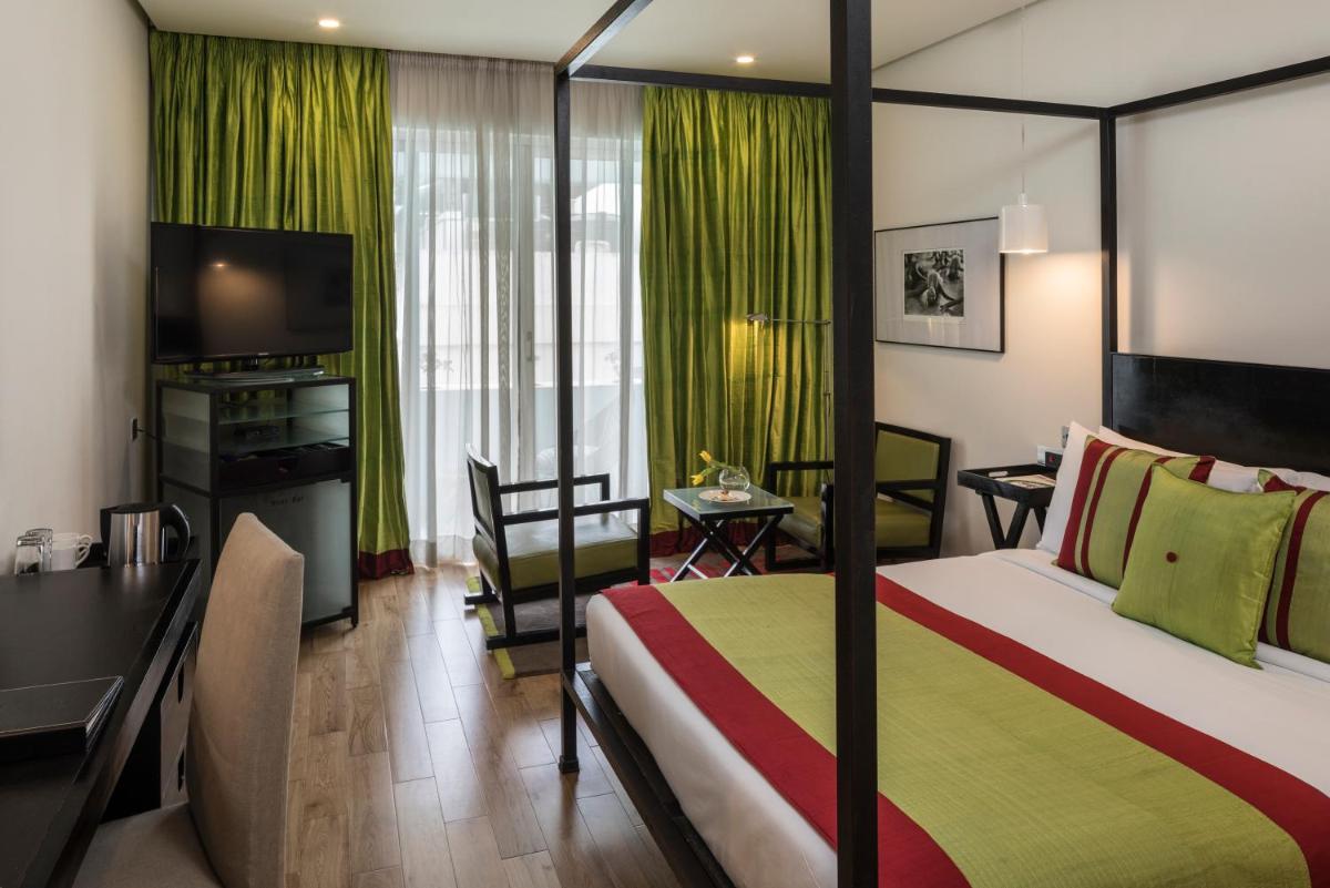 a hotel room with a bed and a desk and a television at The Park Bangalore, MG Road in Bengaluru a hotel room with a bed and a desk and a television at The Park Bangalore, MG Road in Bengaluru