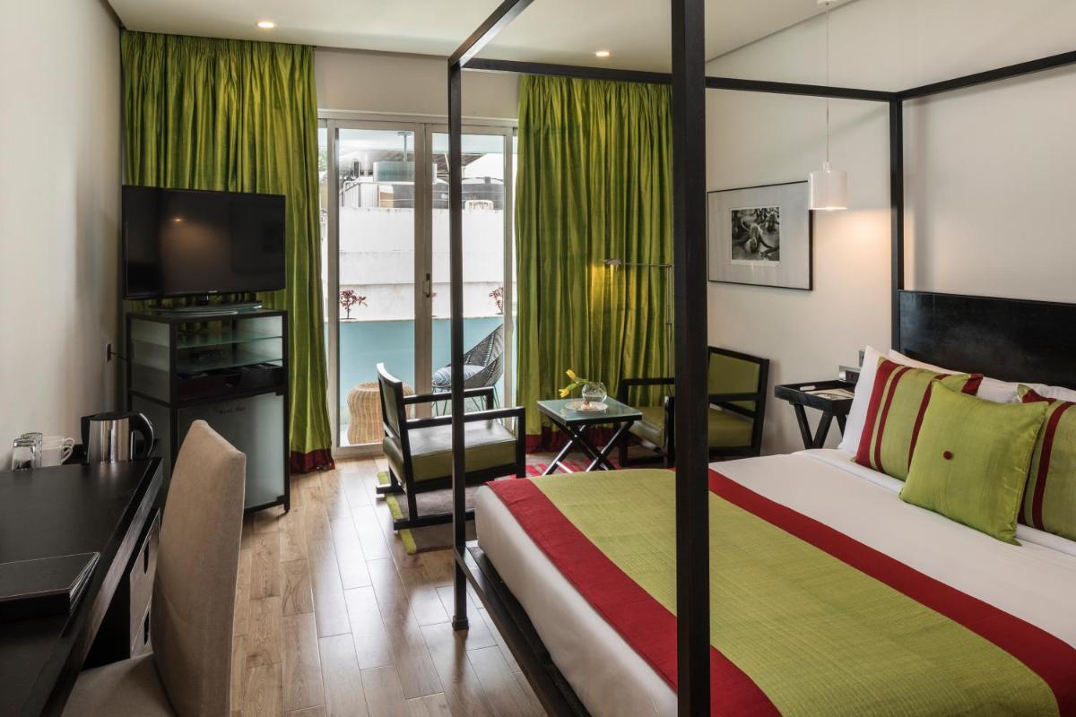 a hotel room with a bed and a desk and a television at The Park Bangalore, MG Road in Bengaluru a hotel room with a bed and a desk and a television at The Park Bangalore, MG Road in Bengaluru