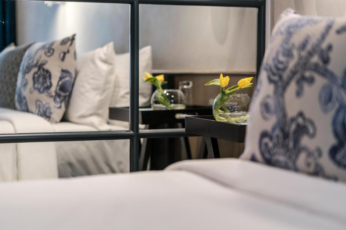 a room with a bed with blue and white pillows at The Park Bangalore, MG Road in Bengaluru a room with a bed with blue and white pillows at The Park Bangalore, MG Road in Bengaluru