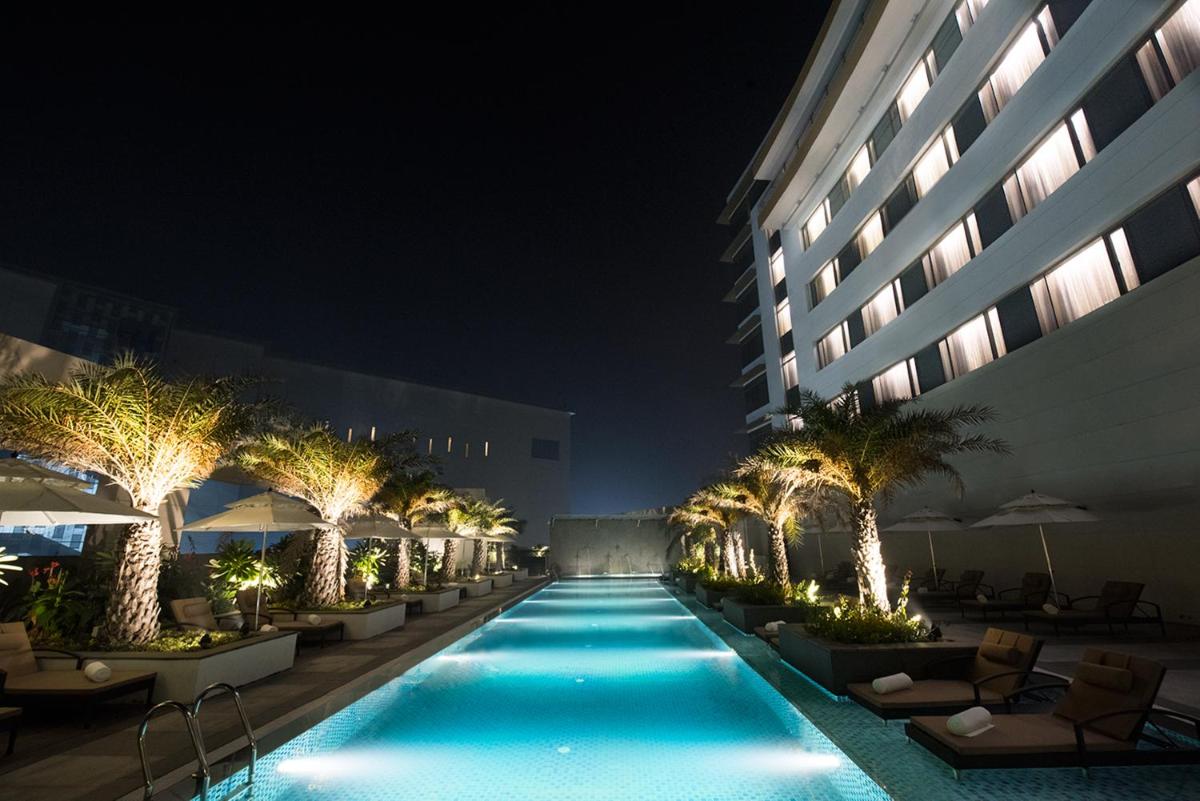 a swimming pool in front of a building at night at Taj Swarna, Amritsar in Amritsar