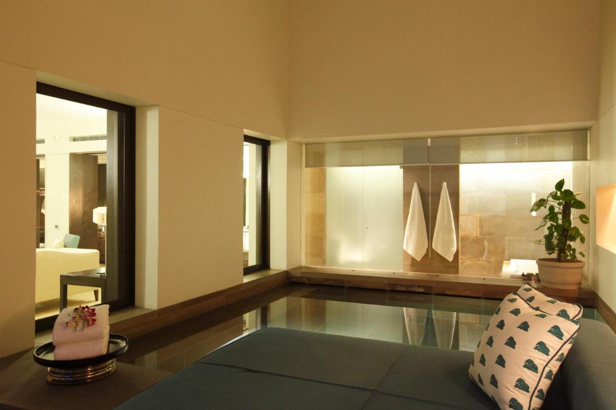 a living room with a couch and a table at The Lodhi – A member of The Leading Hotels Of The World in New Delhi