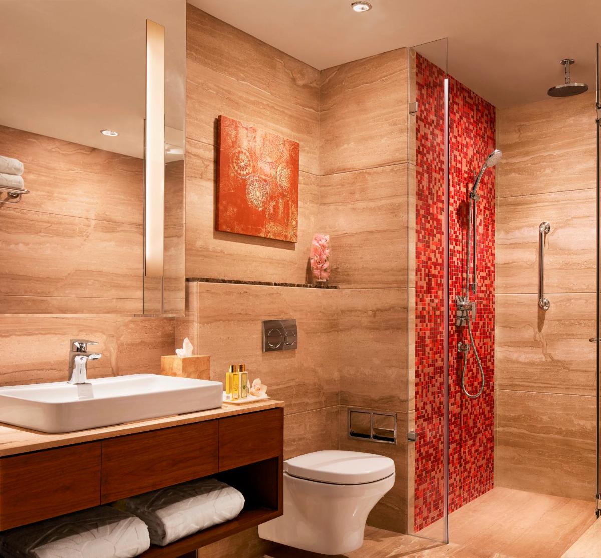a bathroom with a toilet and a sink and a shower at Taj Swarna, Amritsar in Amritsar