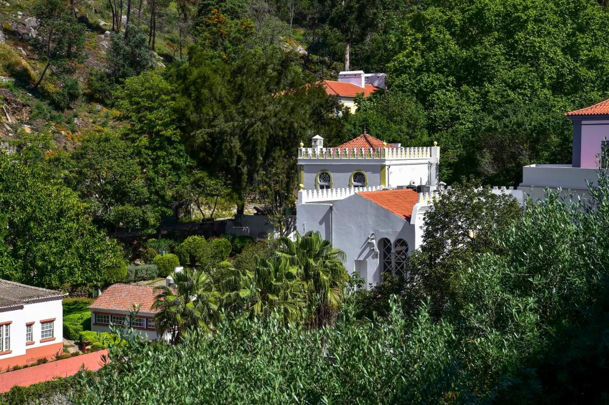 um prédio branco com um telhado vermelho em Central Monchique Hotel - Villa Termal Spa Resort - by Unlock Hotels em Monchique