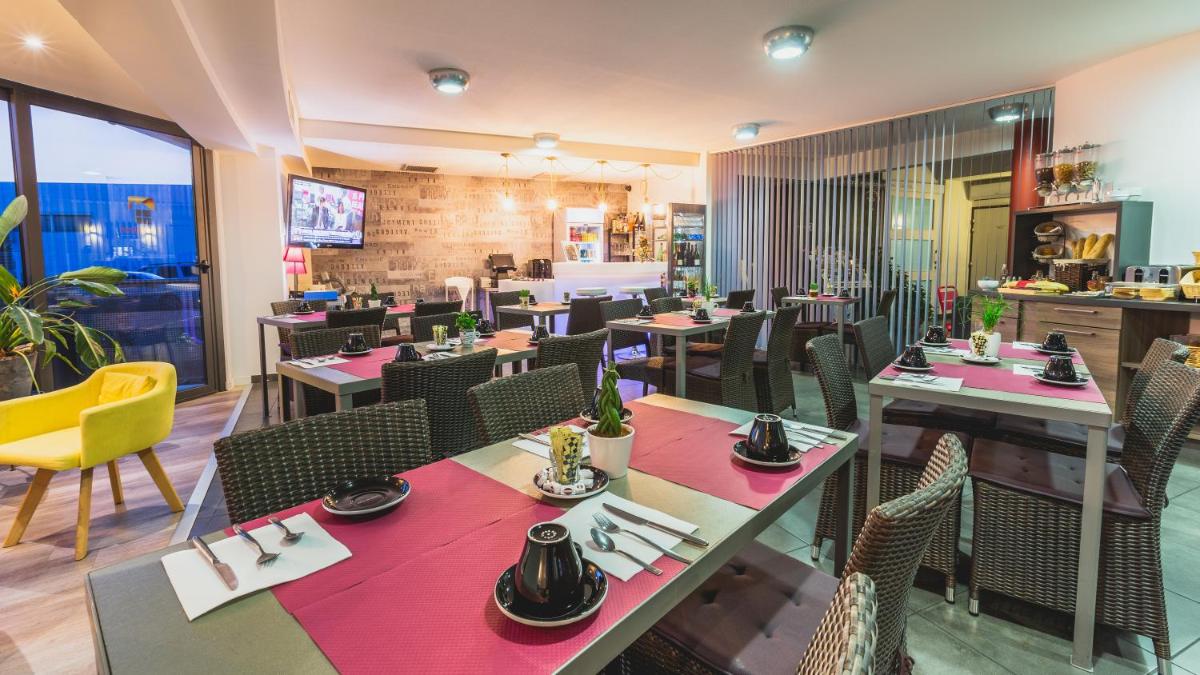 Restaurant ou autre lieu de restauration dans l'établissement The Originals City, Hôtel Les Dômes, Perpignan Sud Saleilles