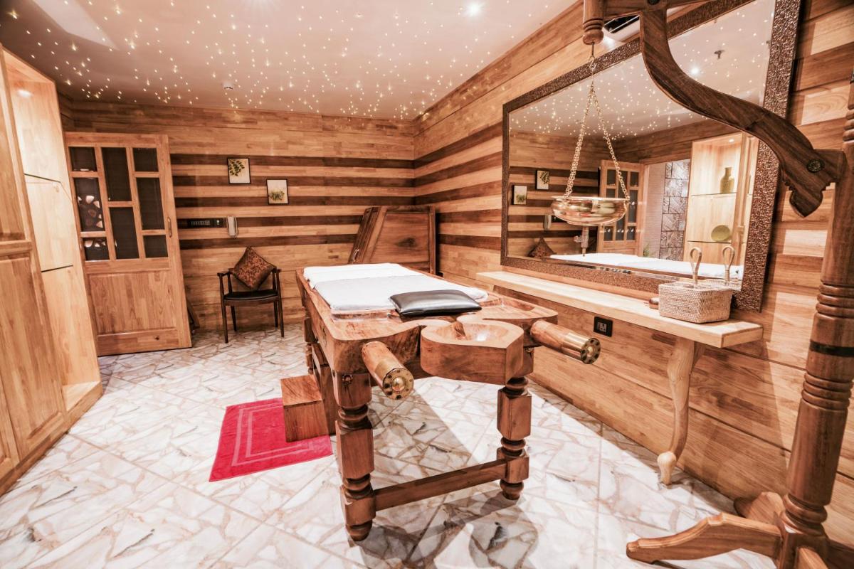 a room with a wooden room with a mirror at The Panoramic Getaway in Munnar