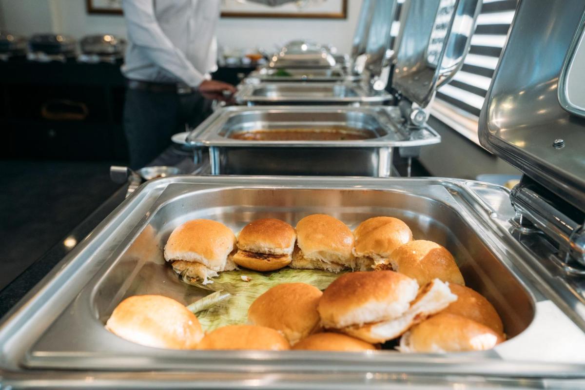 a tray of buns on a buffet line at The Panoramic Getaway in Munnar