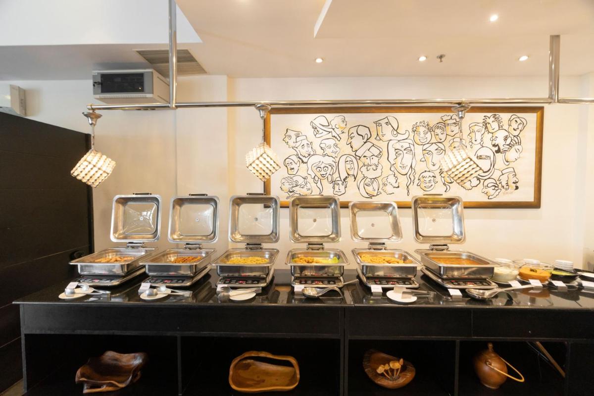 a row of containers of food on a counter at The Panoramic Getaway in Munnar