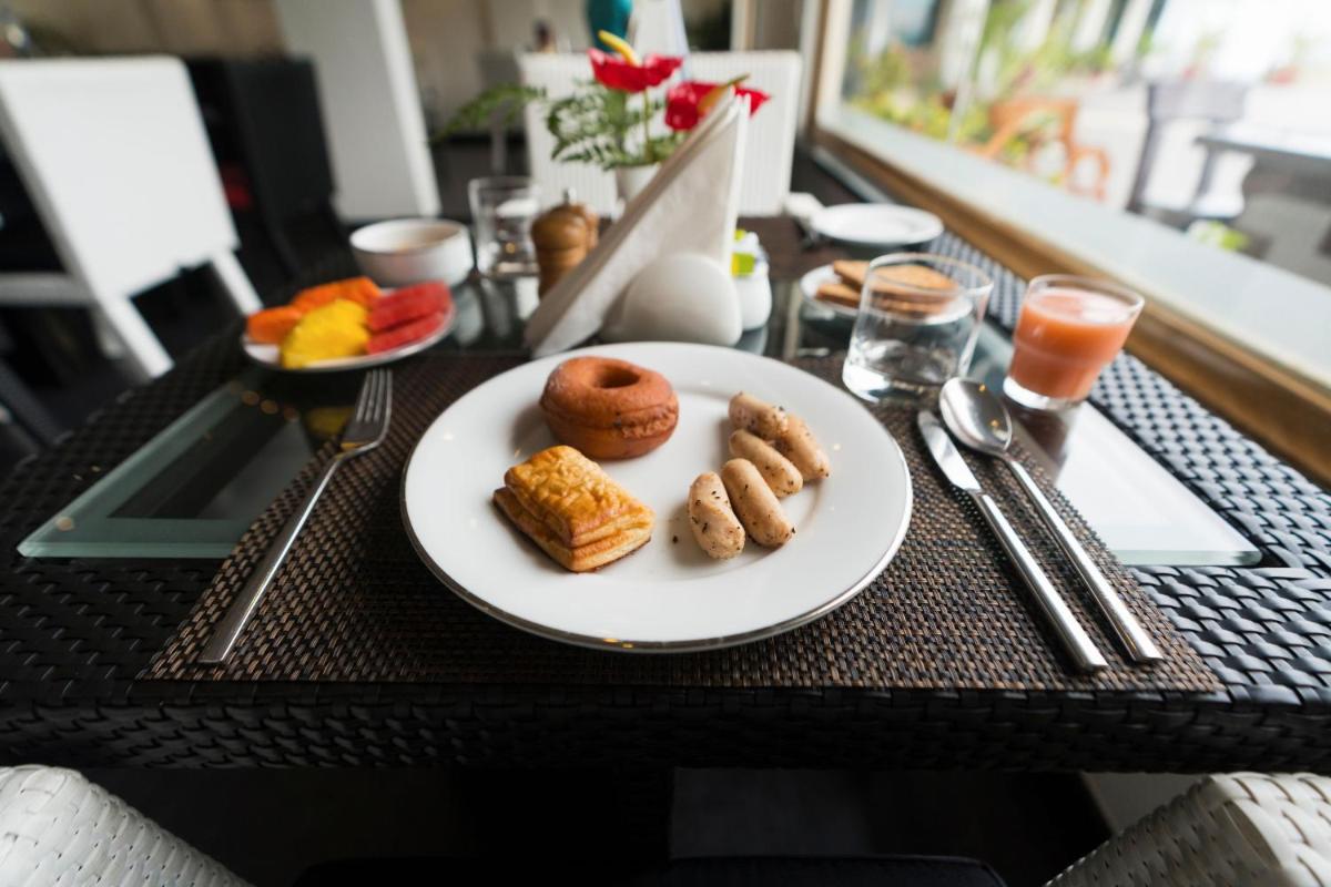 a table with a plate of food on a table at The Panoramic Getaway in Munnar