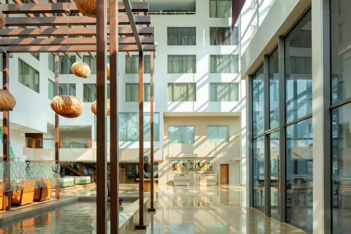 a view of the lobby of a building with glass windows at Radisson Blu Plaza Hotel Hyderabad Banjara Hills in Hyderabad a view of the lobby of a building with glass windows at Radisson Blu Plaza Hotel Hyderabad Banjara Hills in Hyderabad