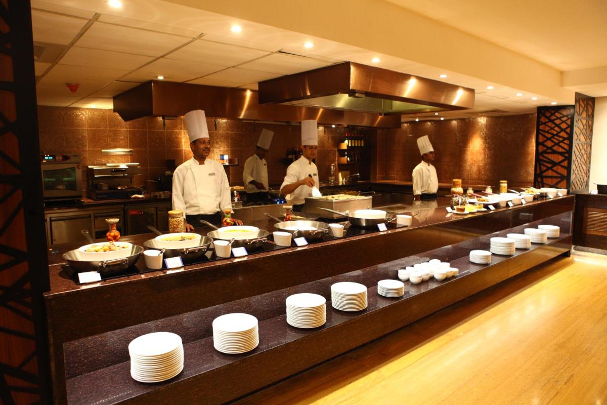 a group of chefs in a kitchen preparing food at Radisson Blu Plaza Hotel Hyderabad Banjara Hills in Hyderabad a group of chefs in a kitchen preparing food at Radisson Blu Plaza Hotel Hyderabad Banjara Hills in Hyderabad
