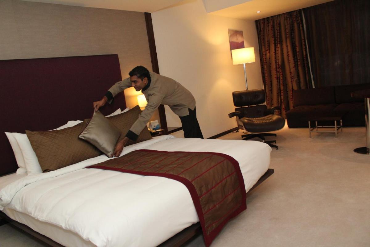 a man is jumping over a bed in a hotel room at Radisson Blu Plaza Hotel Hyderabad Banjara Hills in Hyderabad a man is jumping over a bed in a hotel room at Radisson Blu Plaza Hotel Hyderabad Banjara Hills in Hyderabad