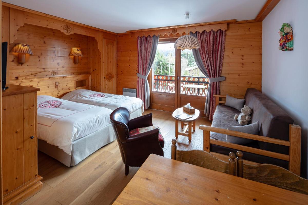 Un ou plusieurs lits dans un hébergement de l'établissement Chalet-Hôtel Neige et Roc, The Originals Relais