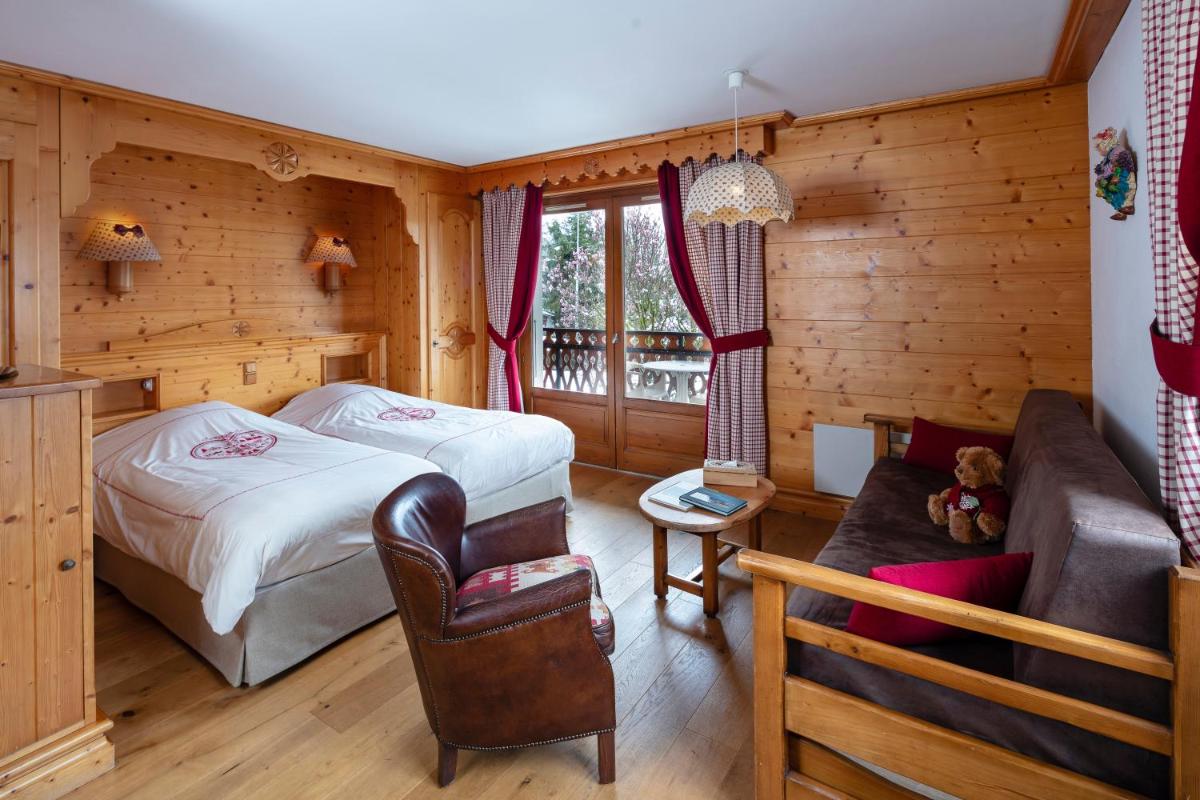 Un ou plusieurs lits dans un hébergement de l'établissement Chalet-Hôtel Neige et Roc, The Originals Relais