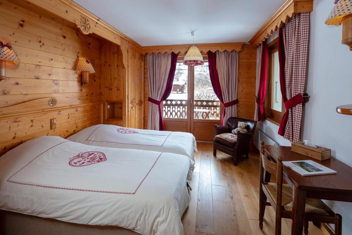 Un ou plusieurs lits dans un hébergement de l'établissement Chalet-Hôtel Neige et Roc, The Originals Relais