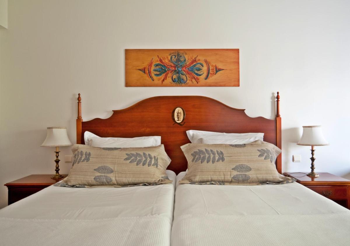 Uma cama ou camas num quarto em Quintinha Sao Joao Hotel & Spa