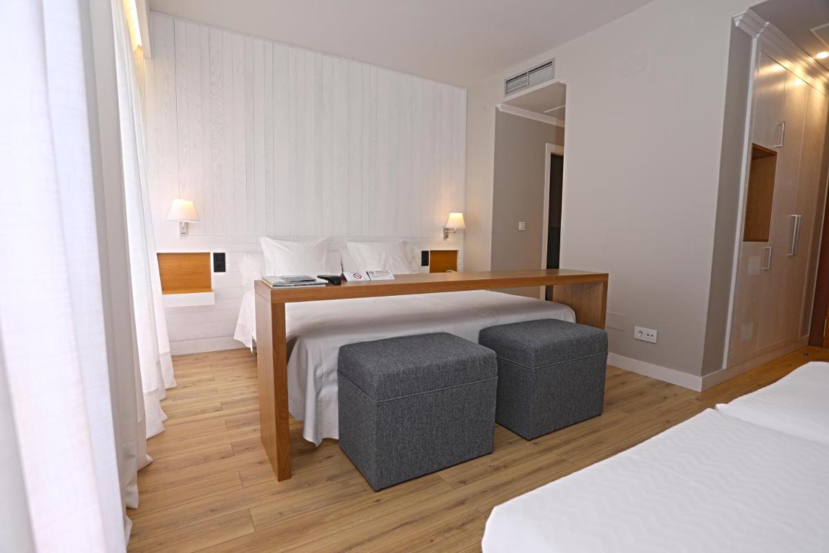 Cama o camas de una habitación en Hotel Spa Atlántico San Vicente do Mar