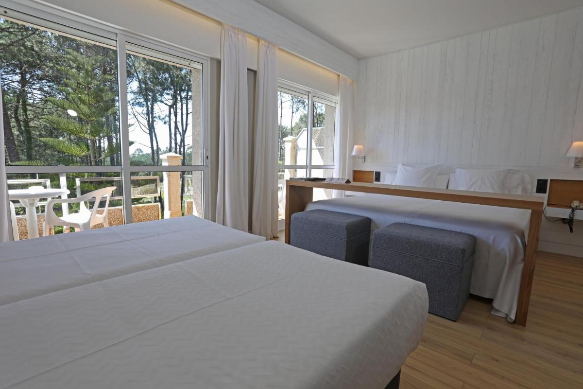 Cama o camas de una habitación en Hotel Spa Atlántico San Vicente do Mar