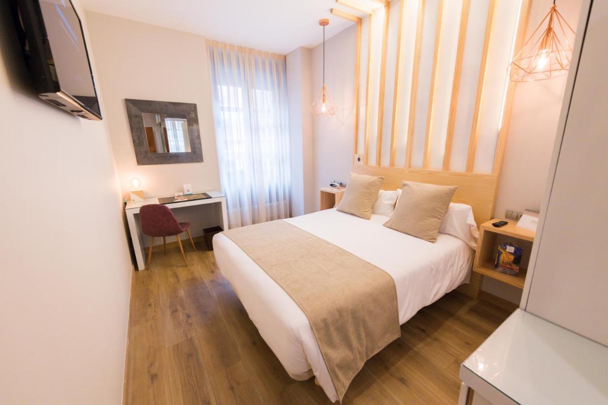 Cama o camas de una habitación en Hotel Fruela