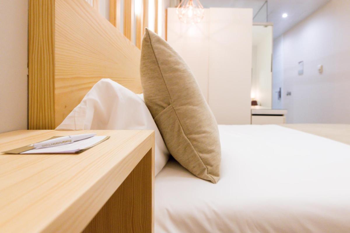 Cama o camas de una habitación en Hotel Fruela