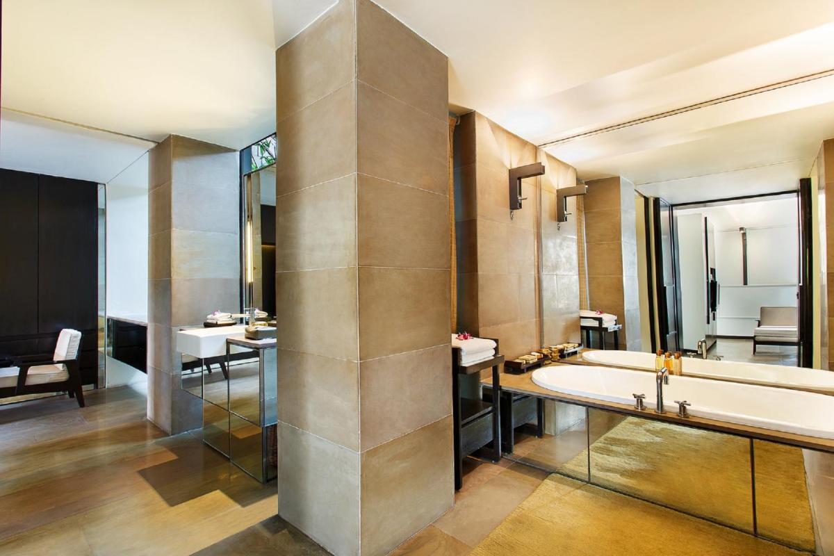 a bathroom with a large tub and a sink at The Lodhi – A member of The Leading Hotels Of The World in New Delhi