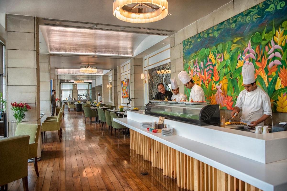 a group of chefs preparing food in a restaurant at The Lodhi – A member of The Leading Hotels Of The World in New Delhi +99 photos