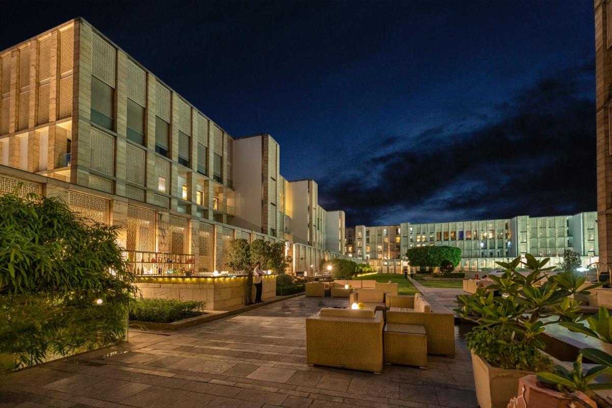 a building with a courtyard in front of it at night at The Lodhi – A member of The Leading Hotels Of The World in New Delhi