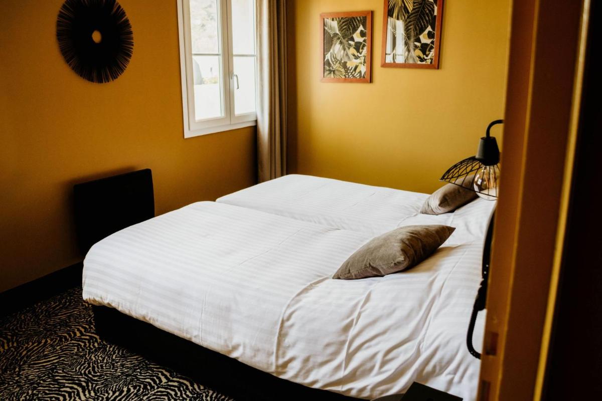 Un ou plusieurs lits dans un hébergement de l'établissement La villa 10 HÔTEL SPA