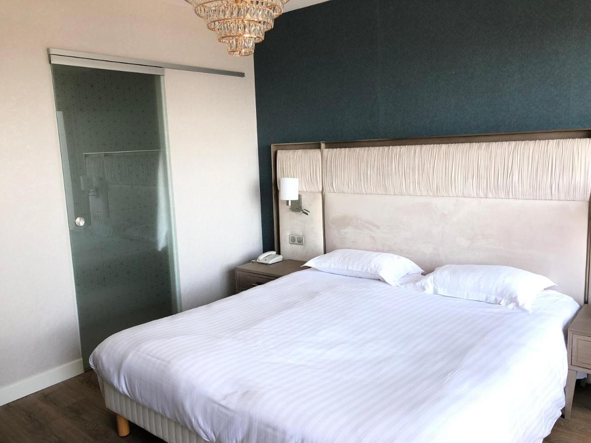 Un ou plusieurs lits dans un hébergement de l'établissement Le Diana Hôtel & Spa