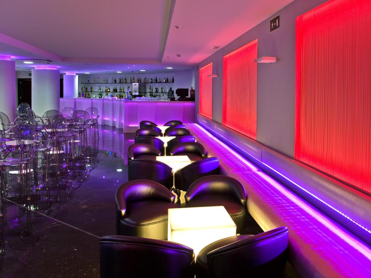 una habitación con sillas y un bar con luces moradas en Hotel Villa del Mar, en Benidorm 145 fotos más