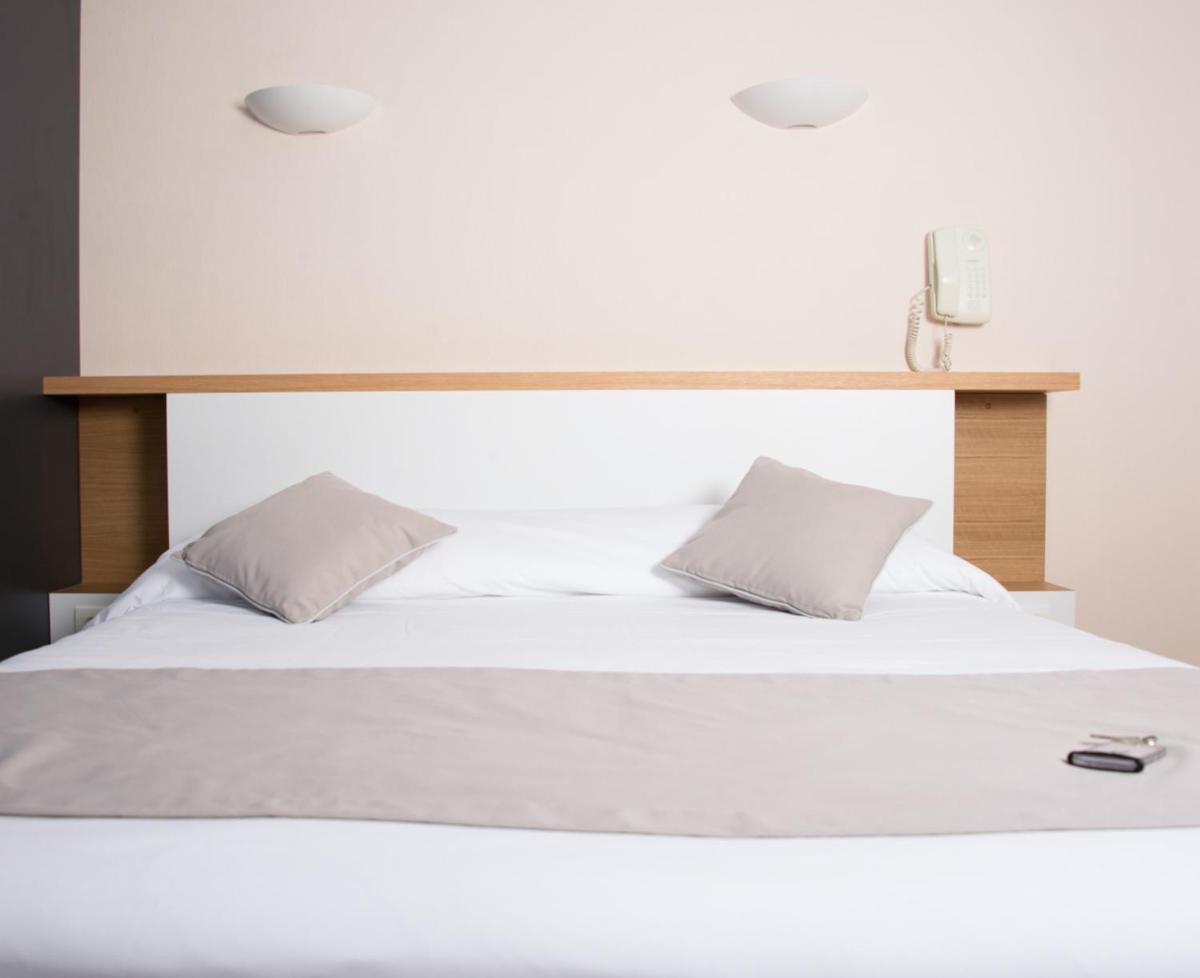 Un ou plusieurs lits dans un hébergement de l'établissement Hotel Les Dunes