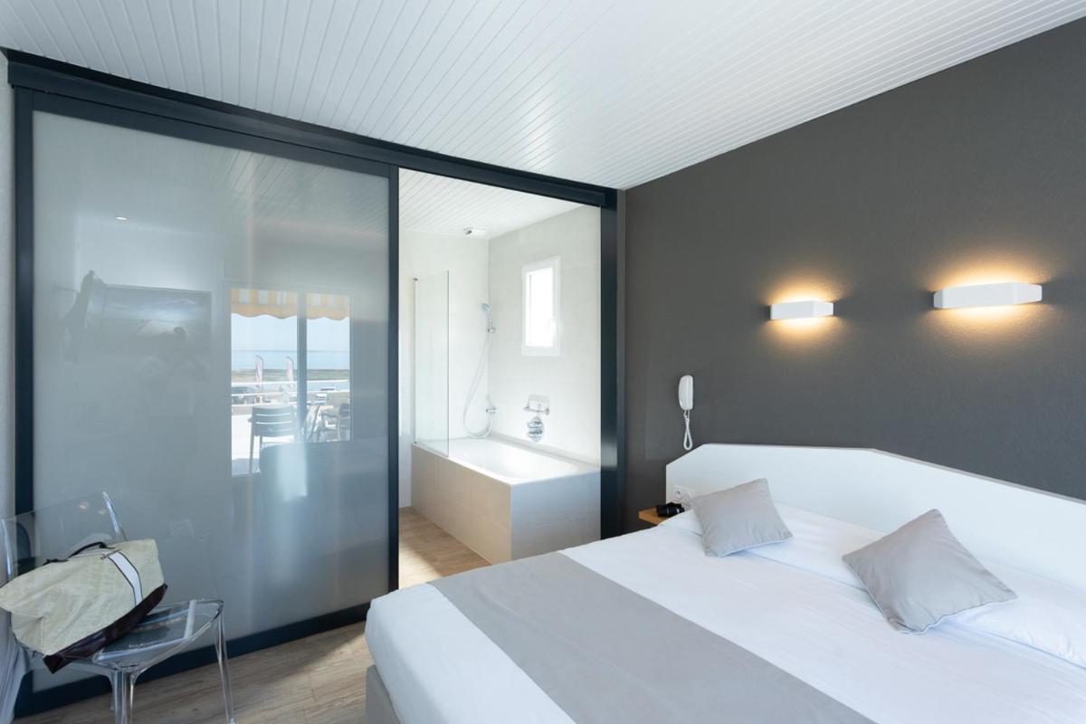Un ou plusieurs lits dans un hébergement de l'établissement Hotel Les Dunes