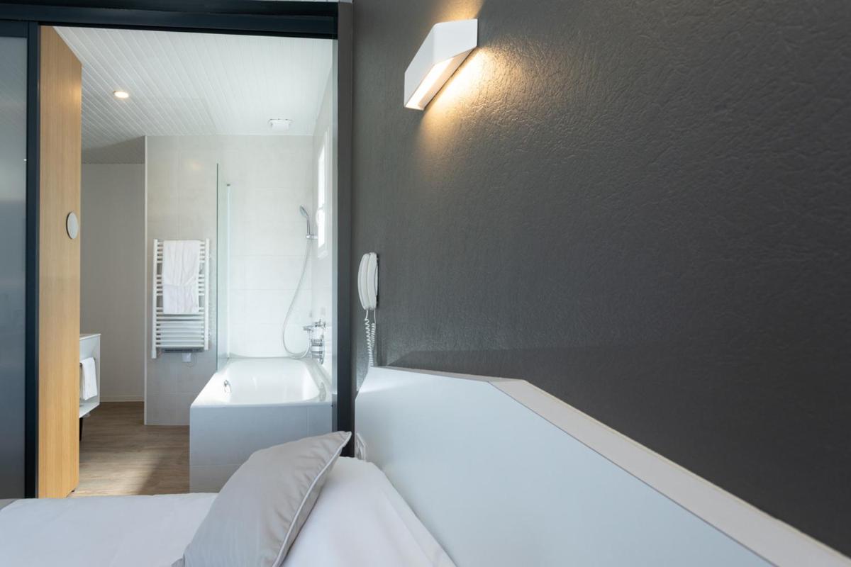 Un ou plusieurs lits dans un hébergement de l'établissement Hotel Les Dunes