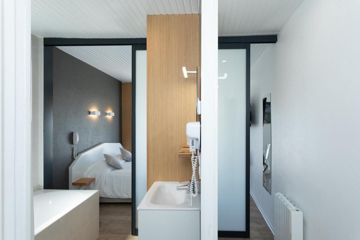 Un ou plusieurs lits dans un hébergement de l'établissement Hotel Les Dunes