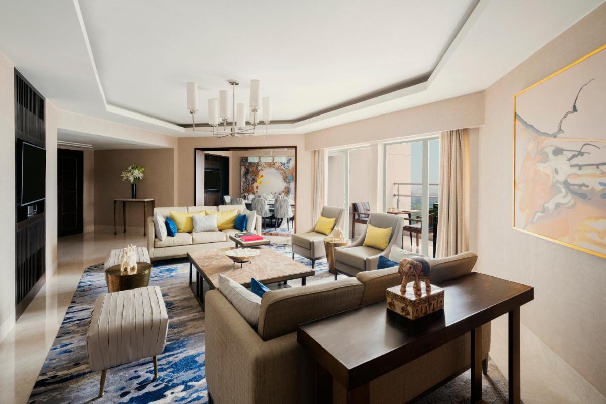a living room with a couch and a table at Shangri-La Eros New Delhi in New Delhi a living room with a couch and a table at Shangri-La Eros New Delhi in New Delhi