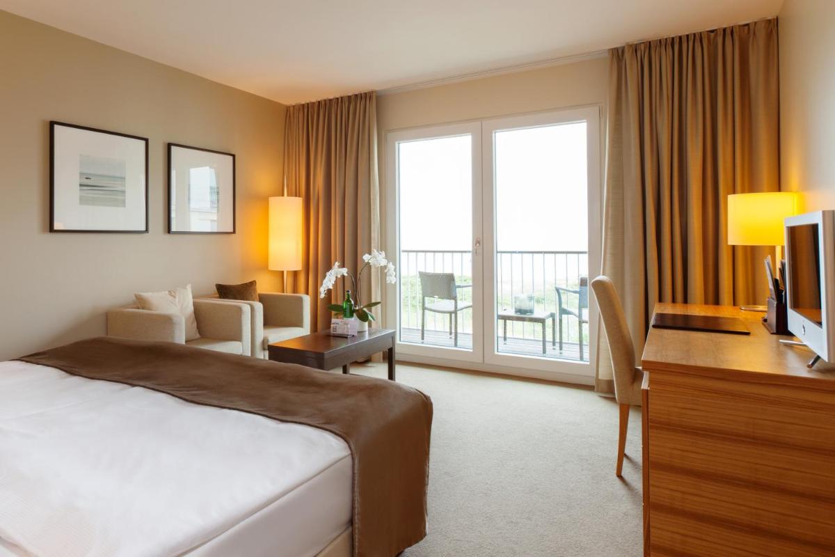 Ein Bett oder Betten in einem Zimmer der Unterkunft A-ROSA Sylt