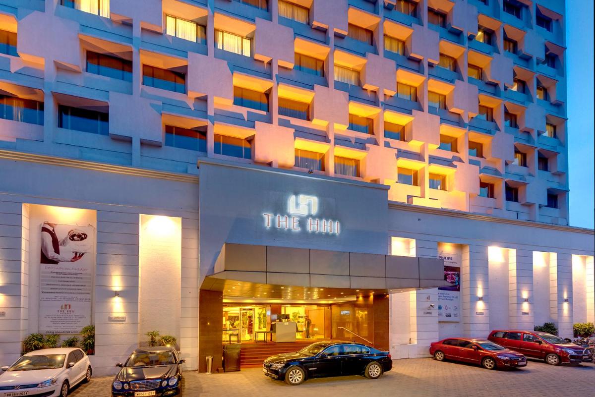 a hotel with cars parked in front of it at Hotel Hindusthan International, Kolkata in Kolkata