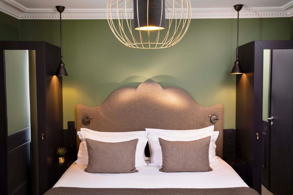 Un ou plusieurs lits dans un hébergement de l'établissement Hotel Monsieur & Spa