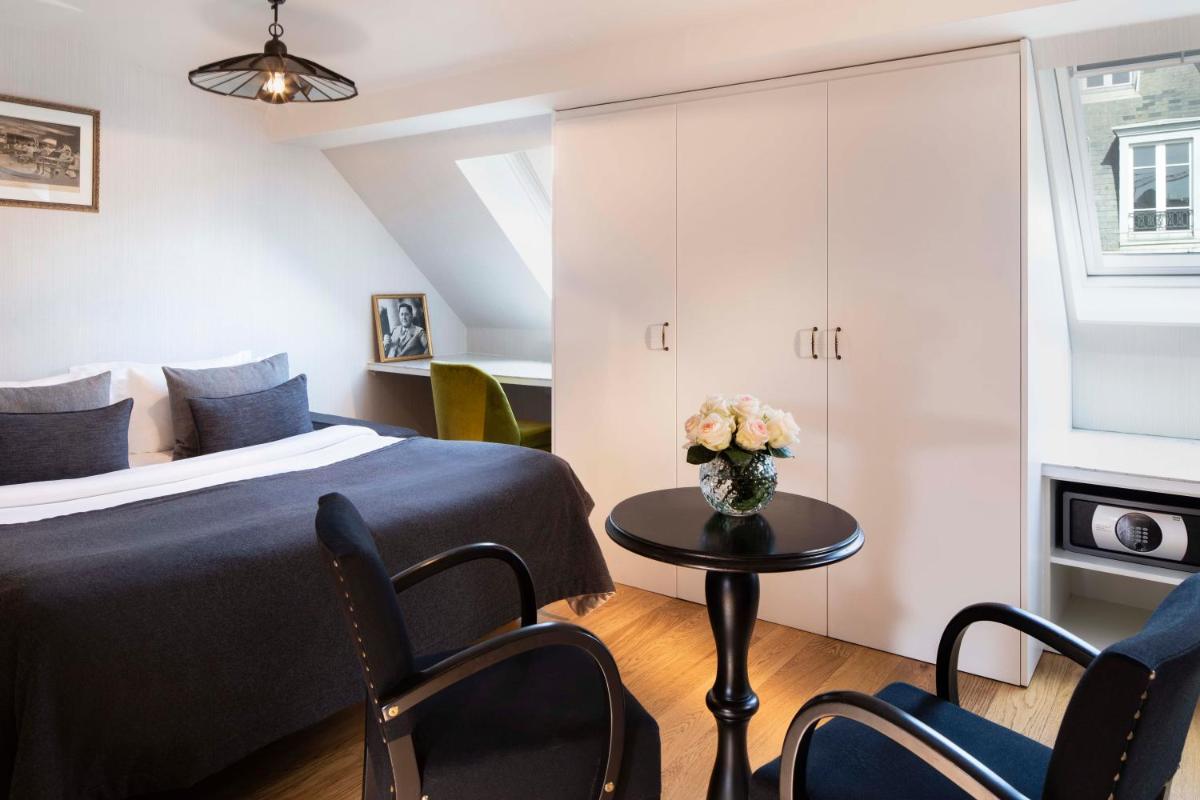 Un ou plusieurs lits dans un hébergement de l'établissement Hotel Monsieur & Spa