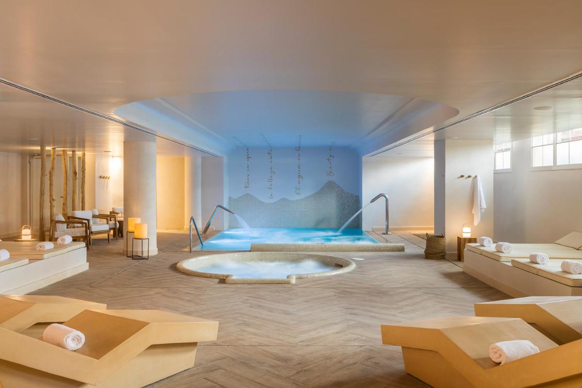 Un baño con bañera en medio de una habitación. en Luna Club Hotel Yoga & Spa 4Sup, en Malgrat de Mar Un baño con bañera en medio de una habitación. en Luna Club Hotel Yoga & Spa 4Sup, en Malgrat de Mar