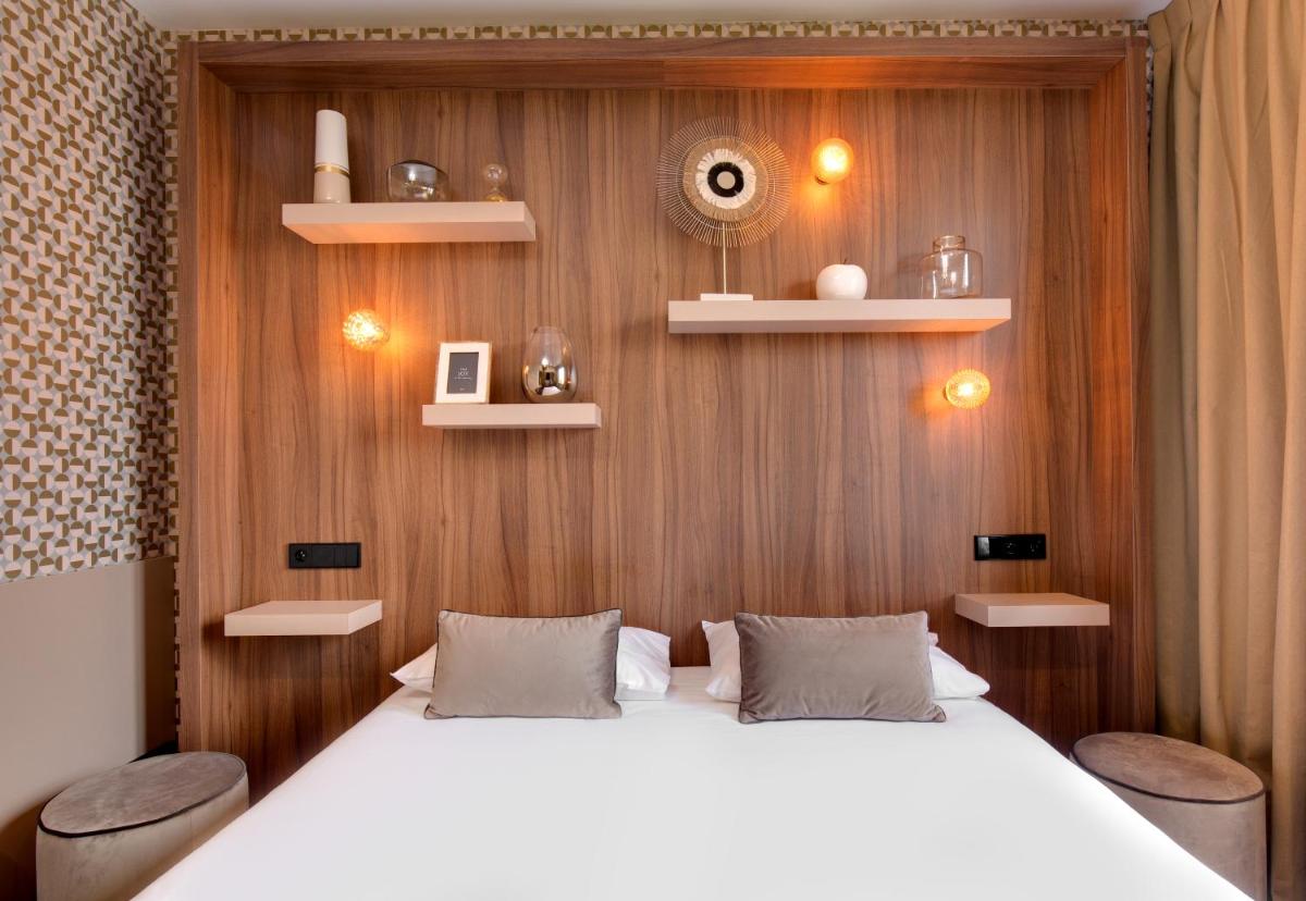 Un ou plusieurs lits dans un hébergement de l'établissement Hôtel Montmorency & Spa