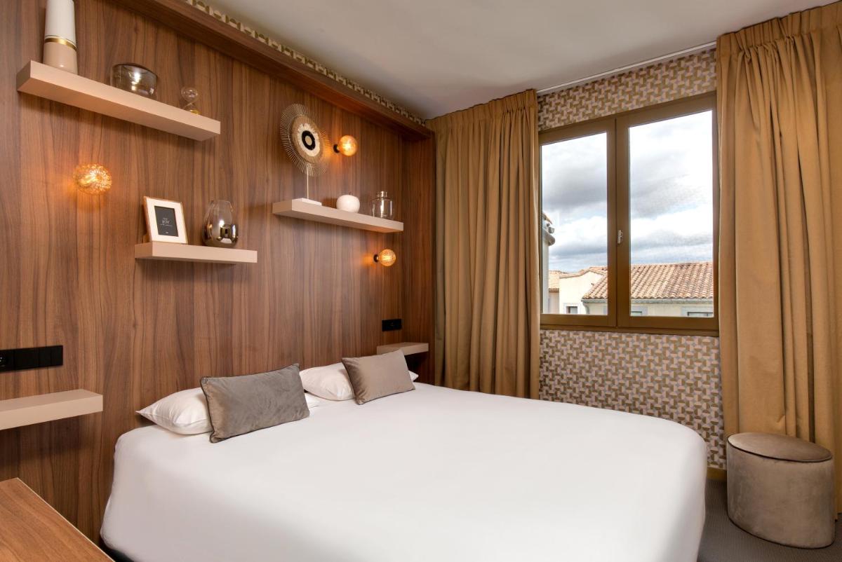 Un ou plusieurs lits dans un hébergement de l'établissement Hôtel Montmorency & Spa