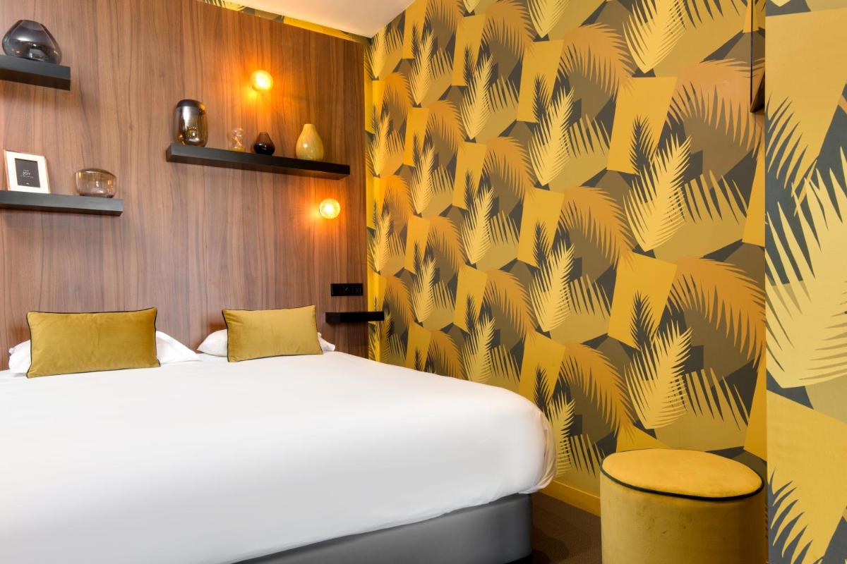 Un ou plusieurs lits dans un hébergement de l'établissement Hôtel Montmorency & Spa