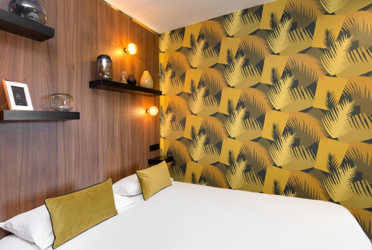 Un ou plusieurs lits dans un hébergement de l'établissement Hôtel Montmorency & Spa